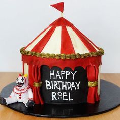 a birthday cake with a circus tent on top