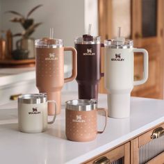 four coffee mugs sitting on top of a counter