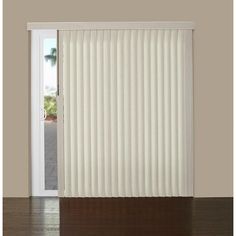 an open door with white vertical blinds on the outside, and wood floors in front