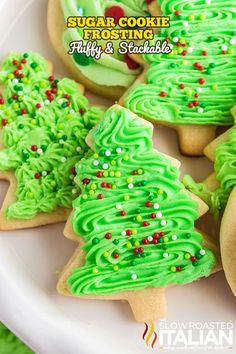 green frosted christmas tree cookies on a white plate