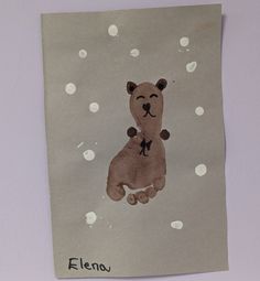 a child's drawing of a teddy bear on a piece of paper with white polka dots