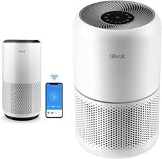 an air purificater next to a smart phone and remote control device