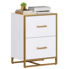 a white and gold colored cabinet with two drawers on each side, next to a printer