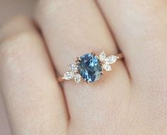 a woman's hand with a blue and white diamond ring