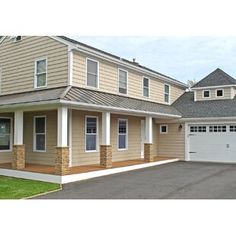 a two story house with garage and driveway