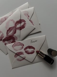 four envelopes with red lipstick on them