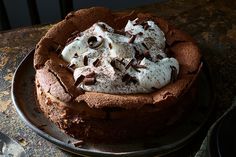 a chocolate cake topped with whipped cream and chocolate chips