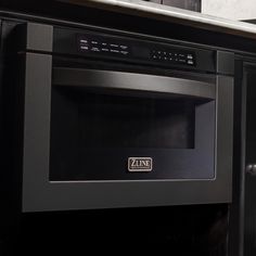 a stainless steel microwave oven with the door open