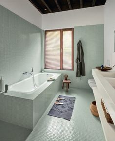 a bathroom with a large bathtub next to a window