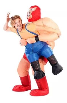 an inflatable wrestler carrying a man on his back