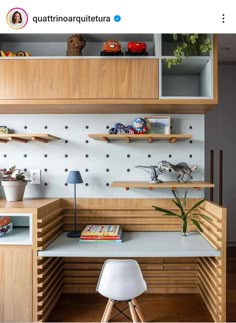 a desk with shelves and books on it in a room that is decorated with wooden shelving