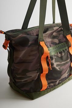 Camo pattern nylon tote bag with contrast webbing accents. Zip top bag with an additional pocket at the front & top carry handles. Features Camo pattern nylon tote bag Allover camo pattern bag Classic zip top tote silhouette Webbing accents Carry handles Content + Care 100% Polyester Spot clean Imported | Camo Pattern Nylon Tote Bag in Camo, Men's at Urban Outfitters Urban Outfitters Bag, Nylon Tote Bag, Pattern Bag, Nylon Tote Bags, Nylon Tote, Zip Top, Bag Pattern, Camo, Urban Outfitters