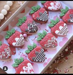 a box filled with lots of decorated cookies