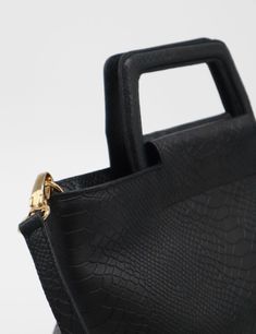 Crafted from luxurious croc-embossed leather, the Courage tote is a timeless companion that effortlessly blends style with practicality. Its sturdy medium-size structure is complemented by two elegant carrying handles and a detachable, adjustable crossbody strap for versatility. The interior has ample space to fit a laptop and your essentials. ETHICALLY HANDCRAFTED BY STIVALI MEASUREMENTS: Length: 12.5" Width: 6" Height: 9" FEATURES/MATERIALS: Croc embossed leather Two carrying top handles Detac Rectangular Textured Leather Bag For On-the-go, Formal Handheld Bag In Textured Leather, Versatile Textured Leather Top Handle Bag, Formal Textured Leather Handheld Bag, Formal Handheld Textured Leather Bag, Leather Tote Box Bag With Adjustable Handle, Leather Box Bag With Adjustable Double Handle, Office Top Handle Box Bag With Adjustable Handle, Office Box Bag With Top Handle And Adjustable Strap