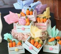 small wooden boxes filled with carrots and baby's breath on top of a table