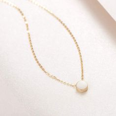 14K Yellow Gold Mother Of Pearl Necklace, Tiny Dot Disc 10mm Minimalist Necklaces For Healing, White Necklace With Delicate Chain, White Minimalist Clavicle Chain Jewelry, Minimalist White Clavicle Chain Jewelry, White Spiritual Necklaces For Everyday Wear, White Birthstone Necklace For Formal Occasions, White Round Pendant Jewelry For Meditation, Spiritual White Clavicle Chain Necklace, Formal White Birthstone Necklace