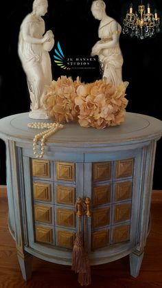 an ornate cabinet with flowers on top