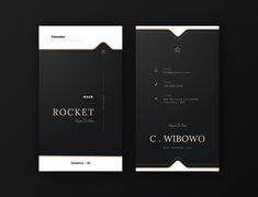 two black and gold business cards on a dark background