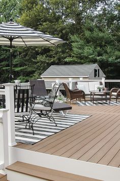 a deck with chairs and an umbrella on it