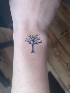 a small tree tattoo on the wrist