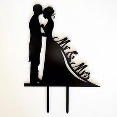 a wedding cake topper with a bride and groom silhouette on it's side