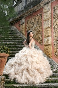 a woman in a wedding dress standing on some steps