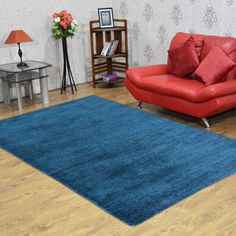 a living room filled with furniture and a blue rug