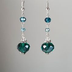 A pair of sparkly long drop earrings in beautiful shades of green/dark turquoise/light blue made with glass crystals, Swarovski crystals, and rhinestones. Perfect for any occasion, weddings and parties or as a gift.   Materials used:  Swarovski crystals, clear (4 mm), glass rondelle crystals, green (12 mm), glass rondelle crystals, dark turquoise blue (6 mm), glass rondelle crystals, light blue (4 mm), rhinestone spacers, silver and antique silver colour plated base metal elements.  Colours:  Gr May Birthstone Crystal Dangle Earrings For Party, Wedding Crystal Dangle Earrings With Faceted Beads, Handmade Green Crystal Earrings For Wedding, Wedding Crystal Earrings With Faceted Beads, Faceted Crystal Drop Earrings For Wedding, Elegant Sterling Silver Crystal Earrings With Faceted Beads, Elegant Turquoise Crystal Earrings Nickel Free, Cheap Blue Crystal Earrings, Elegant Handmade Green Crystal Earrings