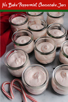 small jars filled with whipped cream next to candy canes and peppermint sticks