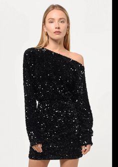 Elevate your style with our stunning Sequin Boatneck Mini Dress in black! The dazzling black sequins add a touch of glamour, while the off the shoulder design and 3/4 sleeves make it a chic and versatile choice for any party. Get ready to turn heads in this must-have mini dress! Off-shoulder Mini Dress For Fall Parties, Chic Mini Sequin Party Dress Fabric, Chic Sequin Fabric For Night Out, Chic Mini Length Sequin Fabric For Party, Chic Mini Sequin Party Dress, Chic Mini-length Sequin Party Fabric, Long Sleeve Dressy Sequin Dress For Holiday Party, Chic Party Mini-length Sequin Fabric, Dressy Long Sleeve Sequin Dress For Holiday Party