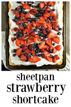 a sheet cake with strawberries and blueberries on top