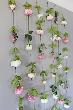 the flowers are hanging on the wall