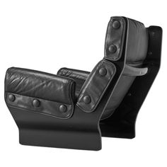 a black leather reclining chair with buttons and rivets on the armrest