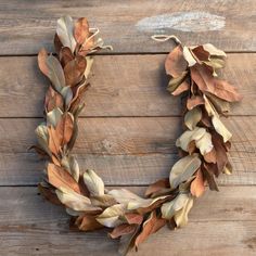 a wreath made out of leaves on top of a wooden table