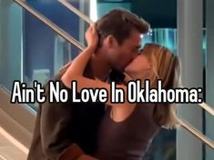 a man and woman kissing in front of a window with the words, ain't no love in oklahoma