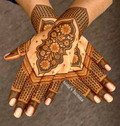 two hands with henna designs on them