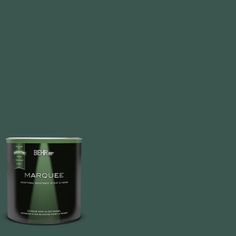 a can of behrorma's marquee green paint on a dark green background