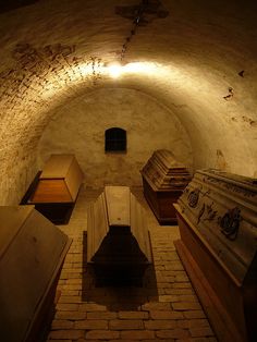 an underground room with several wooden boxes and other items on the floor, all in different shapes and sizes