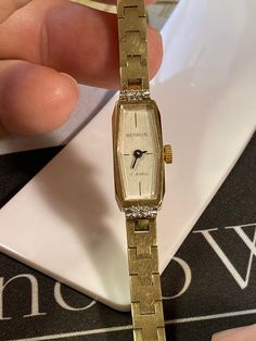 "Excellent working and very good cosmetic condition. 4-Diamond Bezel. Gold tone base metal bezel and stainless steel back case. Comes with a I.D. Hong Kong gold tone metal bracelet. Case size measures 10.4mm x 27.3mm. Wrist size is approximately 6.25\" inches." Rare Vintage Watches Bye Jemis, Luxury Antique Watch Accessories, Luxury Heirloom Watches For Women, Cheap Rectangular Dial Jewelry Gift, Vintage Gold Watch Swisswatchexpo, Vintage Gold Watch, 1970s Bands, Pretty Watches, Metal Bracelet