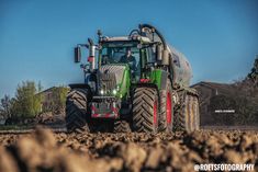 a large tractor is driving through the dirt