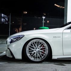 a white car parked in front of a building