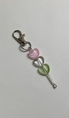 three heart shaped glass beads on a metal keychain