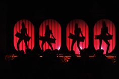 the silhouettes of people are projected on stage