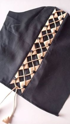 a piece of black fabric with gold trim