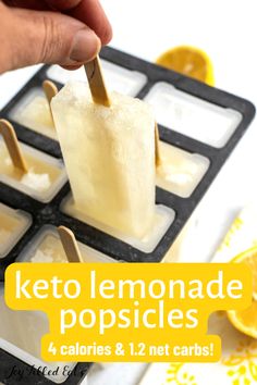 someone dipping lemonade popsicles into ice cubes with toothpicks in them