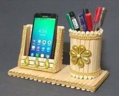 a cell phone and pen holder made out of wood