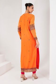 Orange full sleeves A-line kurta with mughal fleur embroidered yoke using sequins, cutdana, thread and nalki highlights. Paired with a fuchsia pink churidar and a bloom floret embroidered dupatta. - Aza Fashions Long Sleeve Churidar With Mirror Work, Orange Traditional Wear With Dupatta And Long Sleeves, Orange Traditional Wear With Long Sleeve And Dupatta, Orange Long Sleeve Traditional Wear With Dupatta, Transitional Long Sleeve Georgette Kurta, Traditional Long Sleeve Churidar With Mirror Work, Orange Long Sleeve Sets With Dabka Work, Long Sleeve Georgette Kurta With Zari Work, Long Sleeve Georgette Kurta With Cutdana