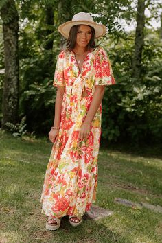 Sway the night away in this gorgeous dress featuring lightweight material patterned with a pretty red/coral, yellow, and lime hued floral print, a v-cut neckline with a front tie accent, short loose sleeves, and a relaxed skirt silhouette that cascades into a straight ankle-length hemline! 
    Measurements S variant has  a Bust of 34",  a Hip of 38",  a Length of 49",  a Sleeve Length of 11",  a Waist of 30".  M variant has  a Bust of 36",  a Hip of 40",  a Length of 50",  a Sleeve Length of 11 Multicolor Floral V-neck Dress With Vibrant Print, V-neck Floral Dress With Vibrant Print For Garden Party, Vacation Floral Dress With Vibrant Print And V-neck, V-neck Floral Dress With Vibrant Print For Vacation, Red Floral V-neck Summer Dress, Red V-neck Floral Summer Dress, Orange V-neck Maxi Dress For Garden Party, Yellow V-neck Floral Dress For Beach, Yellow V-neck Floral Beach Dress