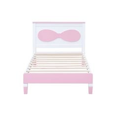 a pink and white bed with a bow headboard on the top of it's frame