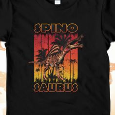 ✪ Spinosaurus Sunset Kids Tee Shirt ✪ Not sure what to get for a young dinosaur enthusiast? What about this Spinosaurus Dinosaur Shirt for kids? I couldn't find the Spinosaurus shirt I was looking for so I decided to make my own!  This Spinosaurus t-shirt features a realistic spinosaurus with an awesome sunset grunge background and spinosaurus wording! The Spinosaurus, similar to the Suchomimus, Baryonyx, and Irritator all belong to the same Spinosaurdae family. Spinosaurids share some of the sa Black Dinosaur Print Short Sleeve T-shirt, Black Short Sleeve T-shirt With Dinosaur Print, Funny Black T-shirt With Dinosaur Print, Carnivorous Dinosaurs, Dinosaur Graphic Tee, Dinosaur Tshirt, Dinosaur Graphic, Kids Tee Shirts, Dinosaur Shirt